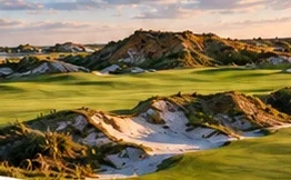 A Streamsong fairway between sand dunes